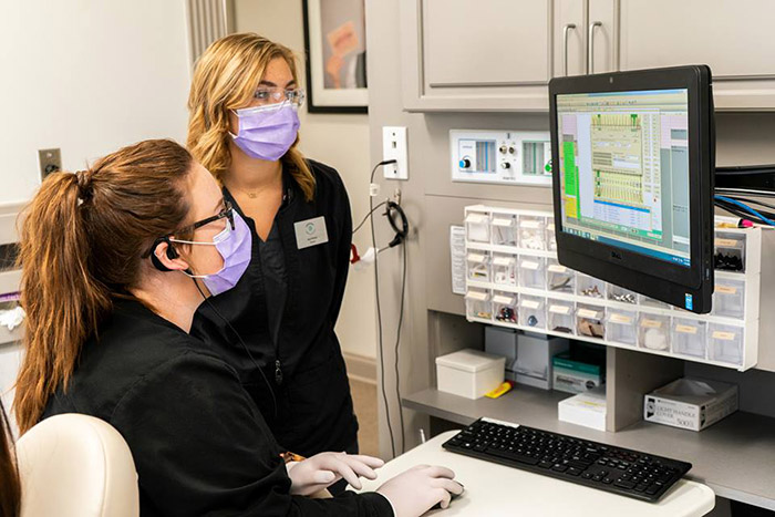 dental professionals reviewing information on a computer
